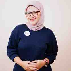 Photo of Farhanah Fitria Mustari (Indonesian woman wearing glasses, cream hijab, blue dress)